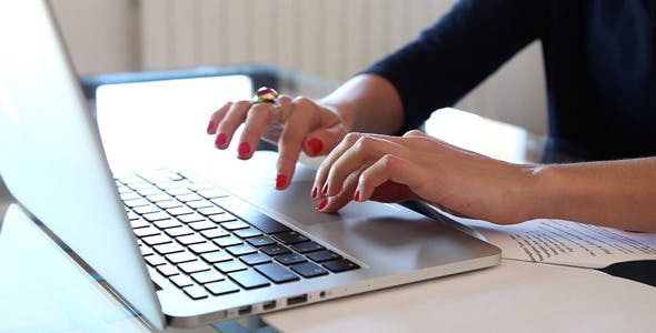 Picture of women's hands typing on a laptop