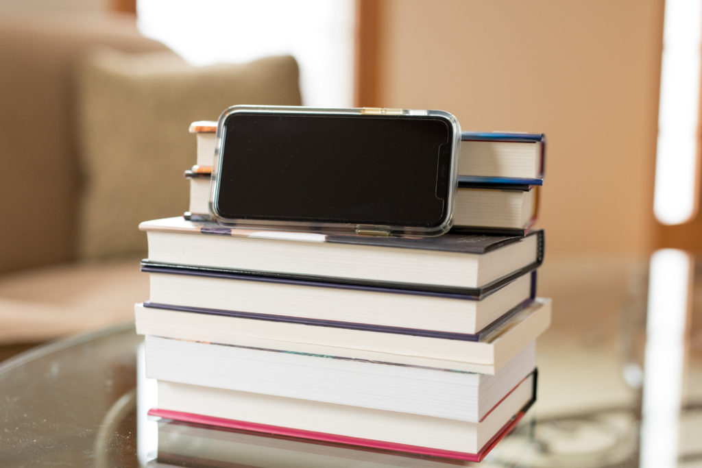 Photo of a phone on a stack of books
